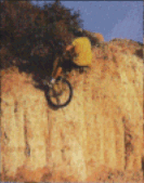 Martin Hawes not quite getting up a 10ft cliff and falling of the back of the bike.